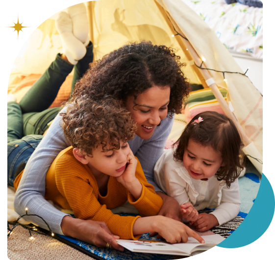Happy family, mom and two children, reading on the floor in a cute tent
